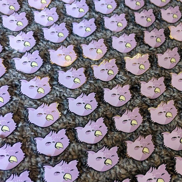 Several rows of owlbare pins on a shaggy gray carpet.